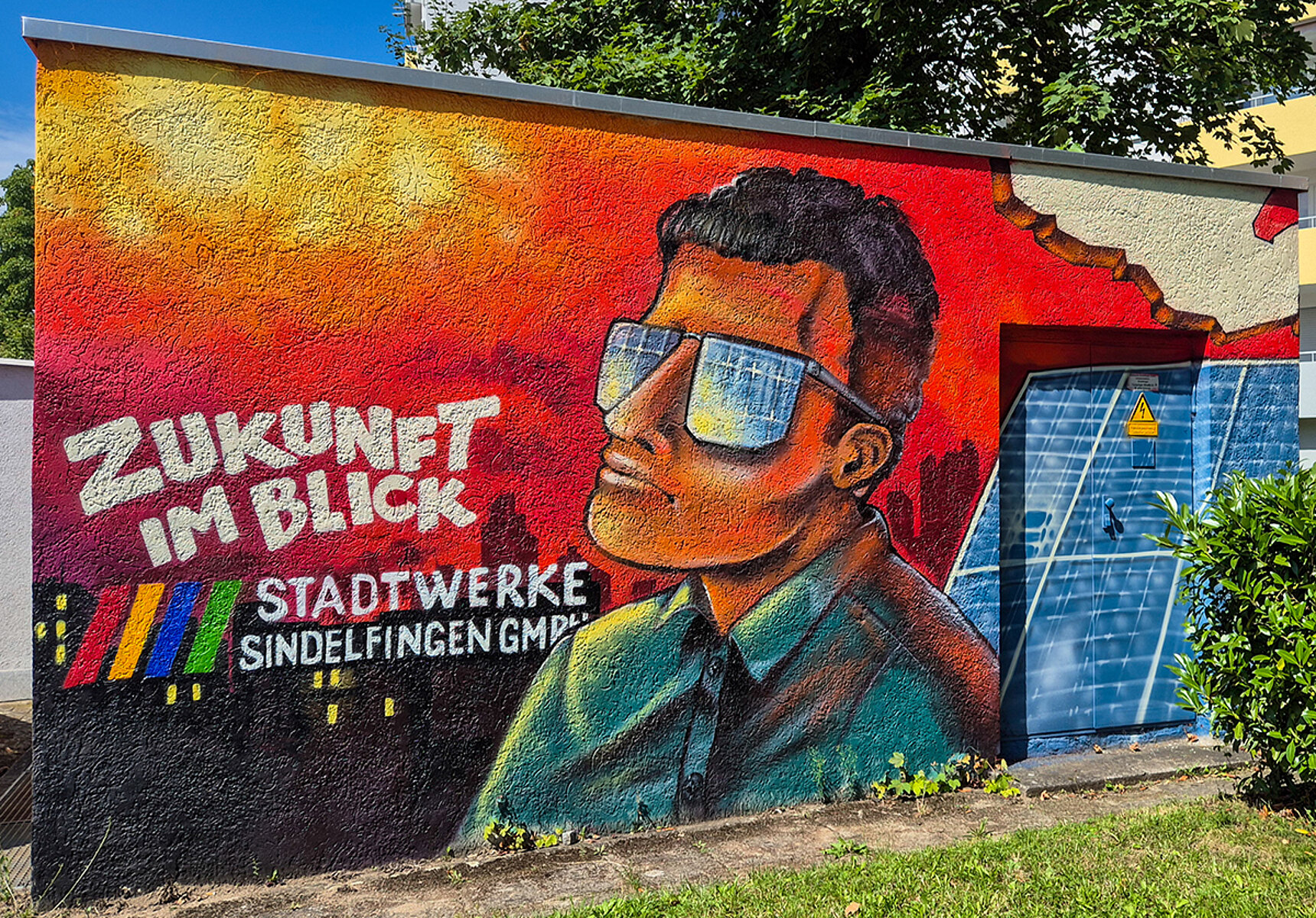 Auf einer Station der Stadtwerke ist ein Graffiti gesprüht. Zu sehen ist ein Mann mit Sonnenbrille, der in die Sonne schaut. Daneben ist der Satz Zukunft im Blick und das Logo der Stadtwerke Sindelfingen angebracht